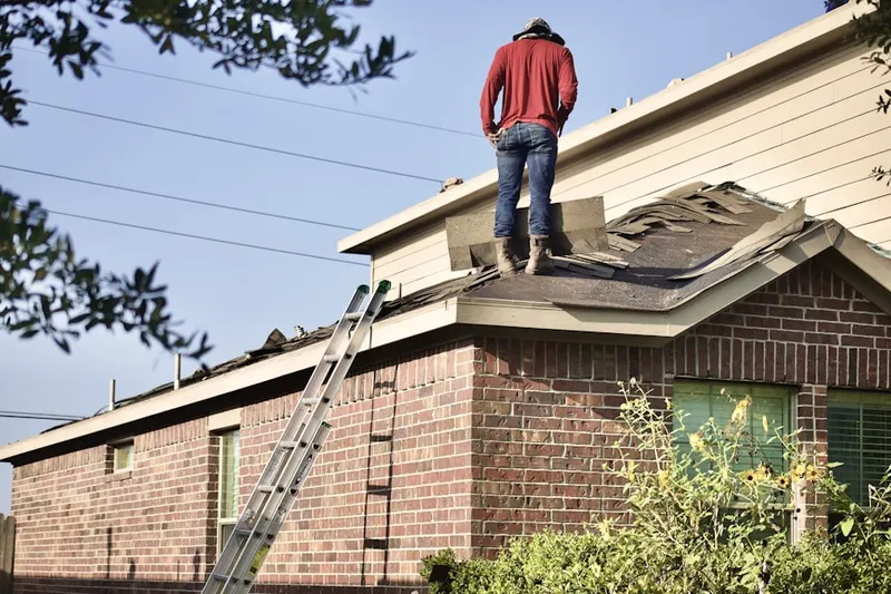 Professional roofer working on a residential roof in Williams Crossing